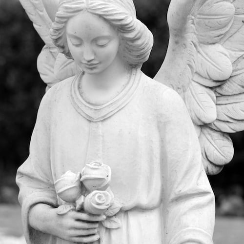 angel statue holding roses cemetery death