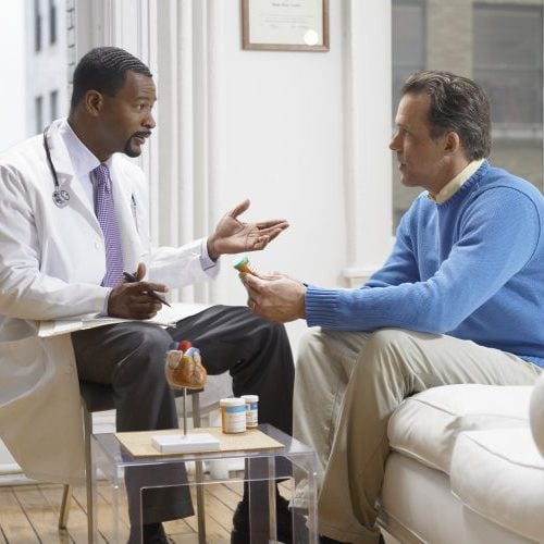 Doctor Discussing Medicine in His Clinic With a Patient