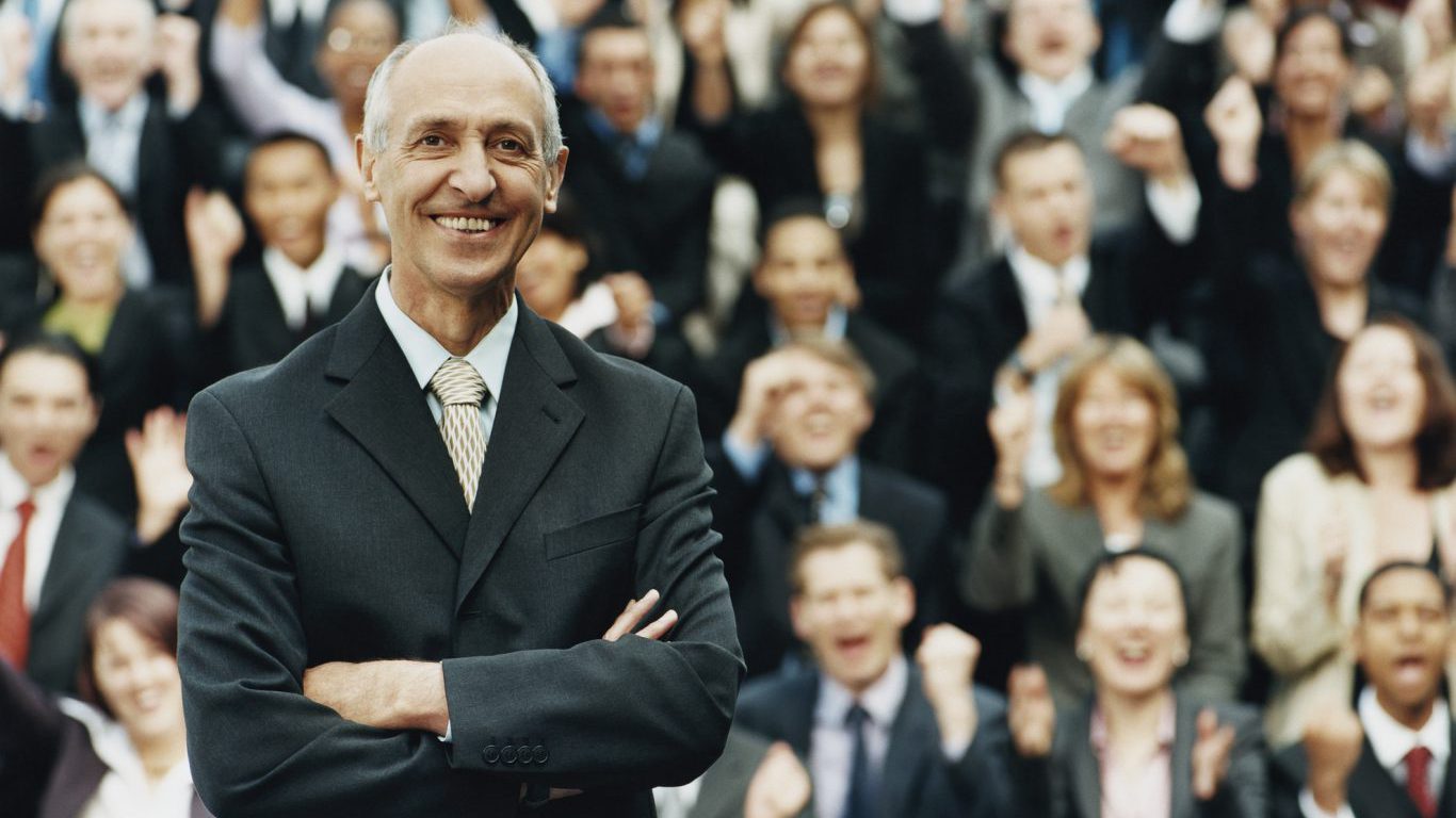 Male CEO Standing in Front of a Large Group of Business People
