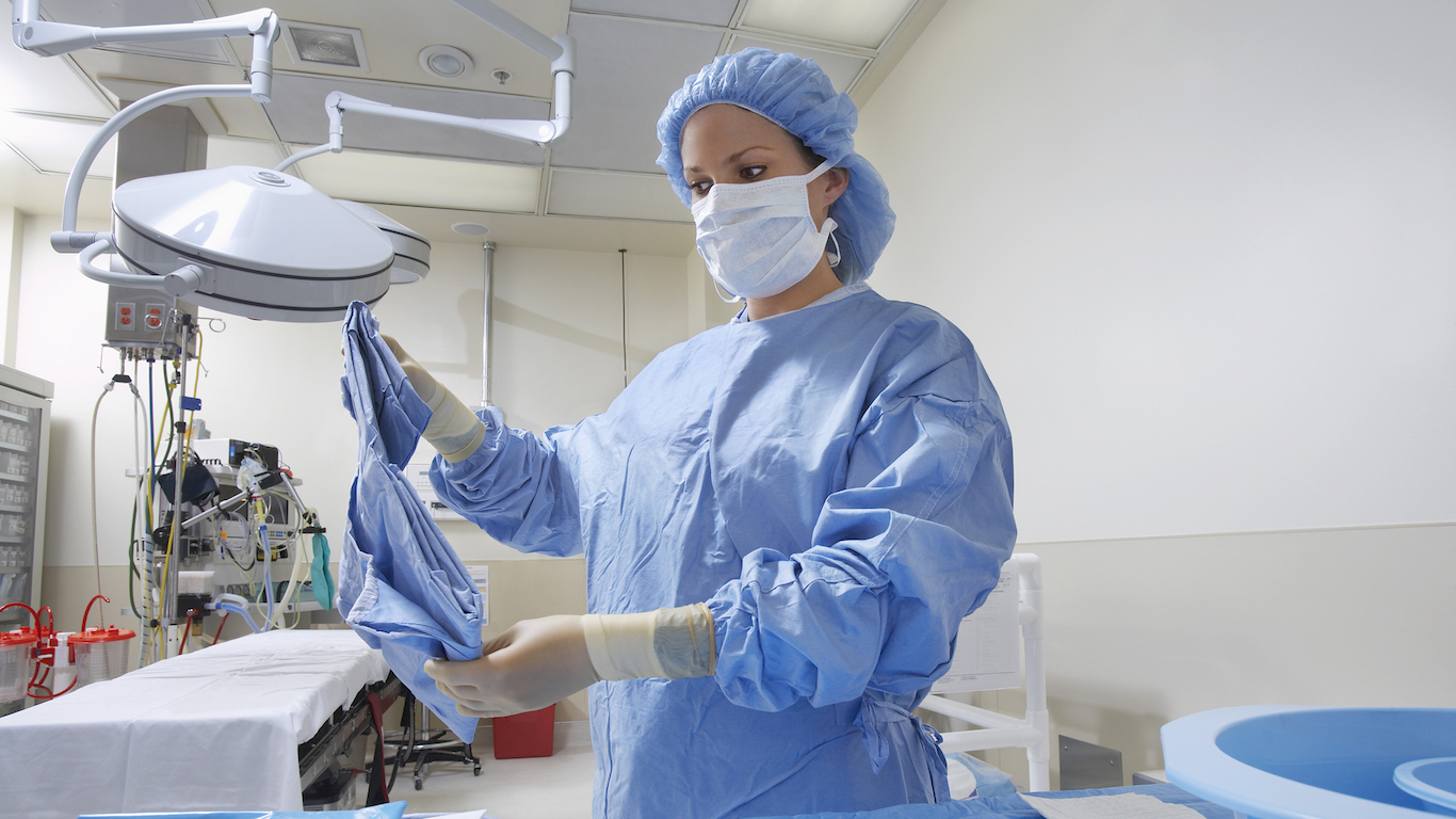 Nurse preparing bed in operating room, Hospital