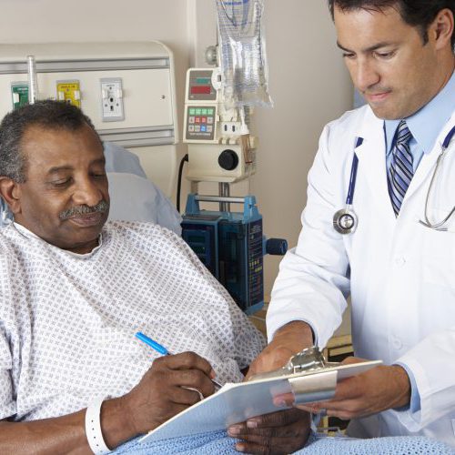 Doctor Explaining Consent Form To Senior Patient