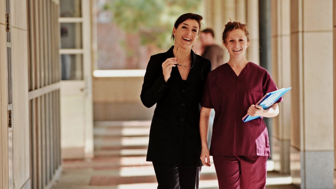 Female Doctor and Nurse walking down corridor