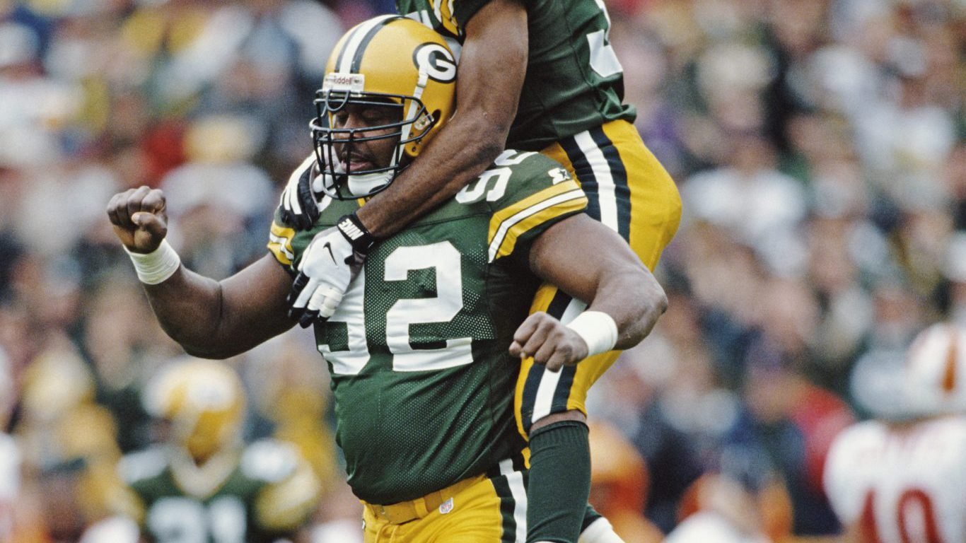 Reggie White #92, Defensive End for the Green Bay Packers gives a piggyback to team mate Doug Evans during the National Football Conference Central game against the Tampa Bay Buccaneers on 27 October 1996 at Lambeau Field, Green Bay, Wisconsin, United States. The Packers won the game 13 - 7.  (Photo by Jonathan Daniel/Allsport/Getty Images)