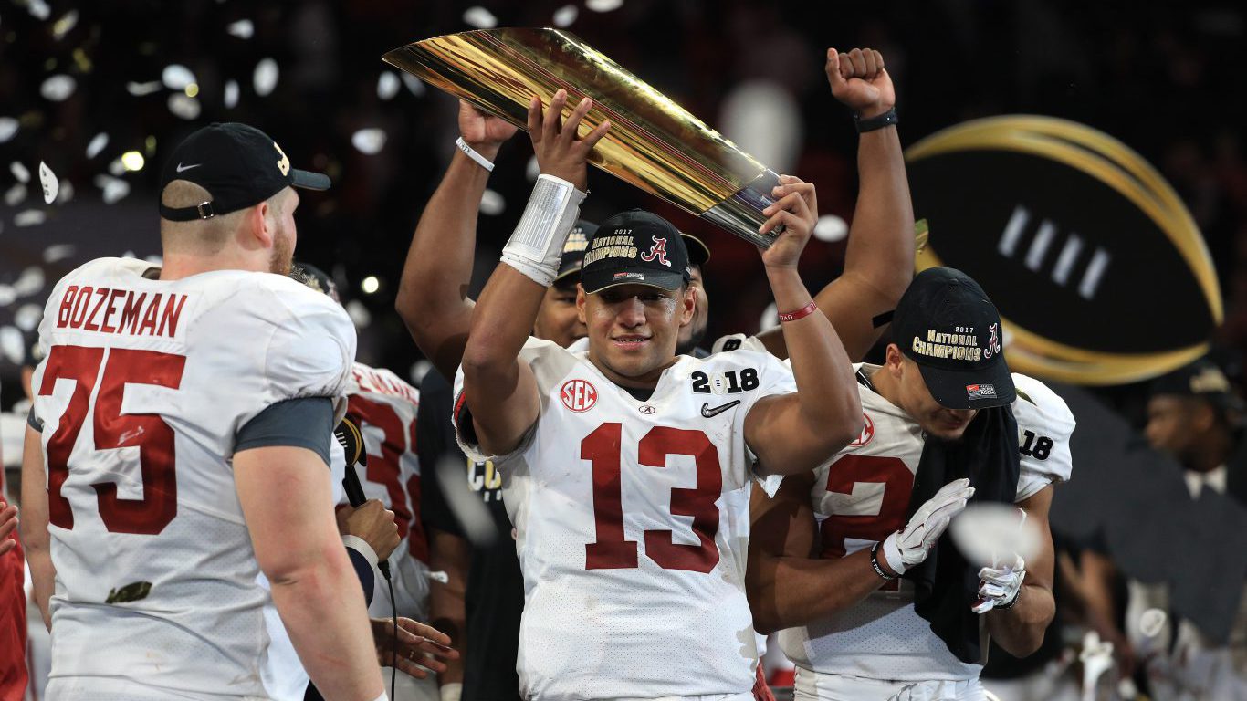 ATLANTA, GA - JANUARY 08: Tua Tagovailoa #13 of the Alabama Crimson Tide holds the trophy while celebrating with his team after defeating the Georgia Bulldogs in overtime to win the CFP National Championship presented by AT&amp;T at Mercedes-Benz Stadium on January 8, 2018 in Atlanta, Georgia. (Photo by Mike Ehrmann/Getty Images)
