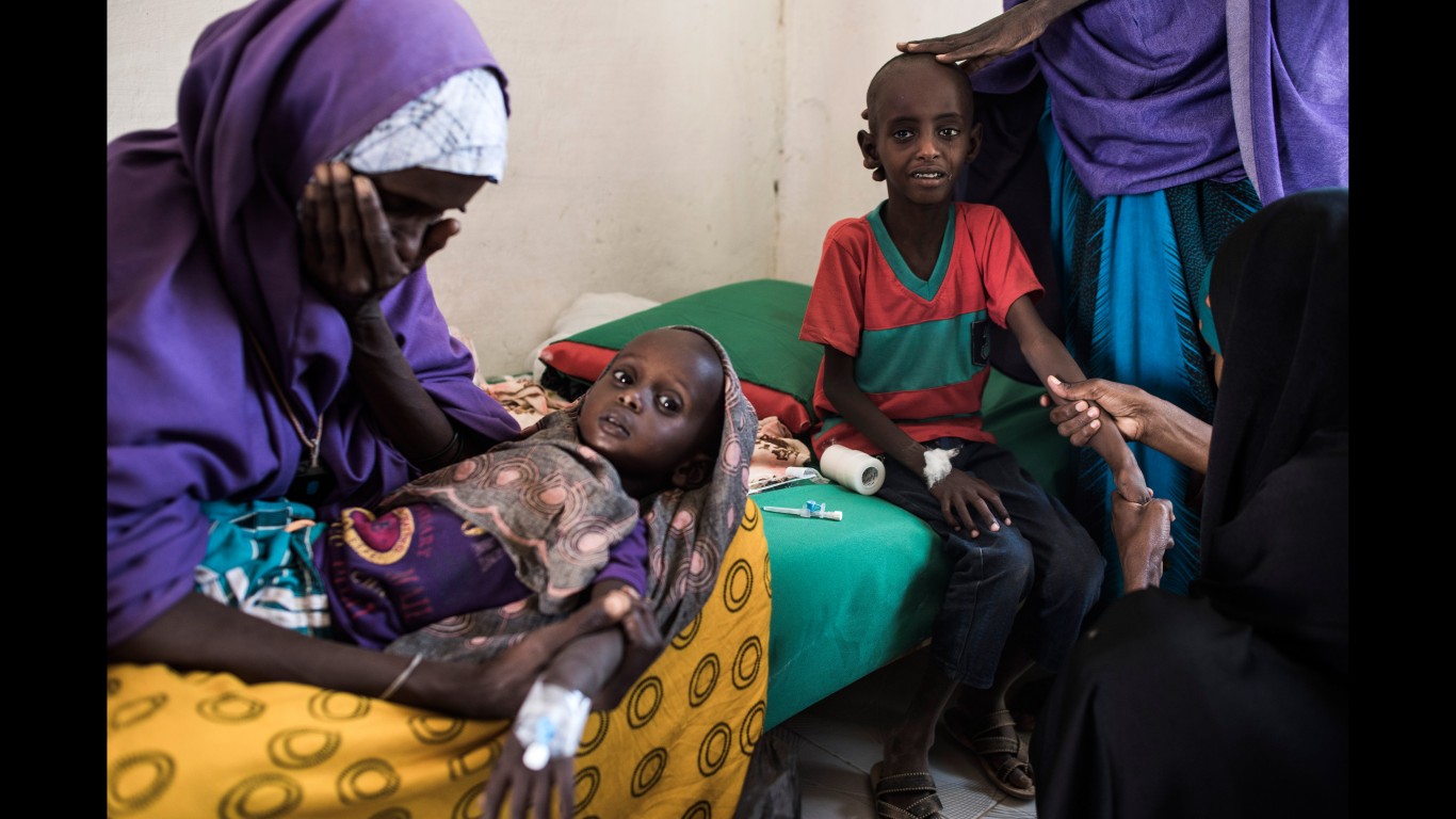 SHADA, SOMALIA - FEBRUARY 25: Abdullahi Mohamud, 5, cries next to his mother Sahro Mohamed Mumin, 30, and brother, Abdulrahman Mahamud, 2, as a nurse struggles to find a vein for an injection at a government run health clinic on February 25, 2017 in Shada, Somalia. Abdullahi was diagnosed with bronchitis, Abdulrahman with pneumonia. Both children were also suffering from severe malnutrition.The family lost all of their animals due to drought and had traveled 150 kilometers in search of a better situation. Somalia is currently on the brink of famine with over half of the country's population facing acute food insecurity according to the United Nations. The intensifying crisis has humanitarian groups racing to stop a repeat of 2011, in which 260,000 people died of famine throughout country.  (Photo by Andrew Renneisen/Getty Images)