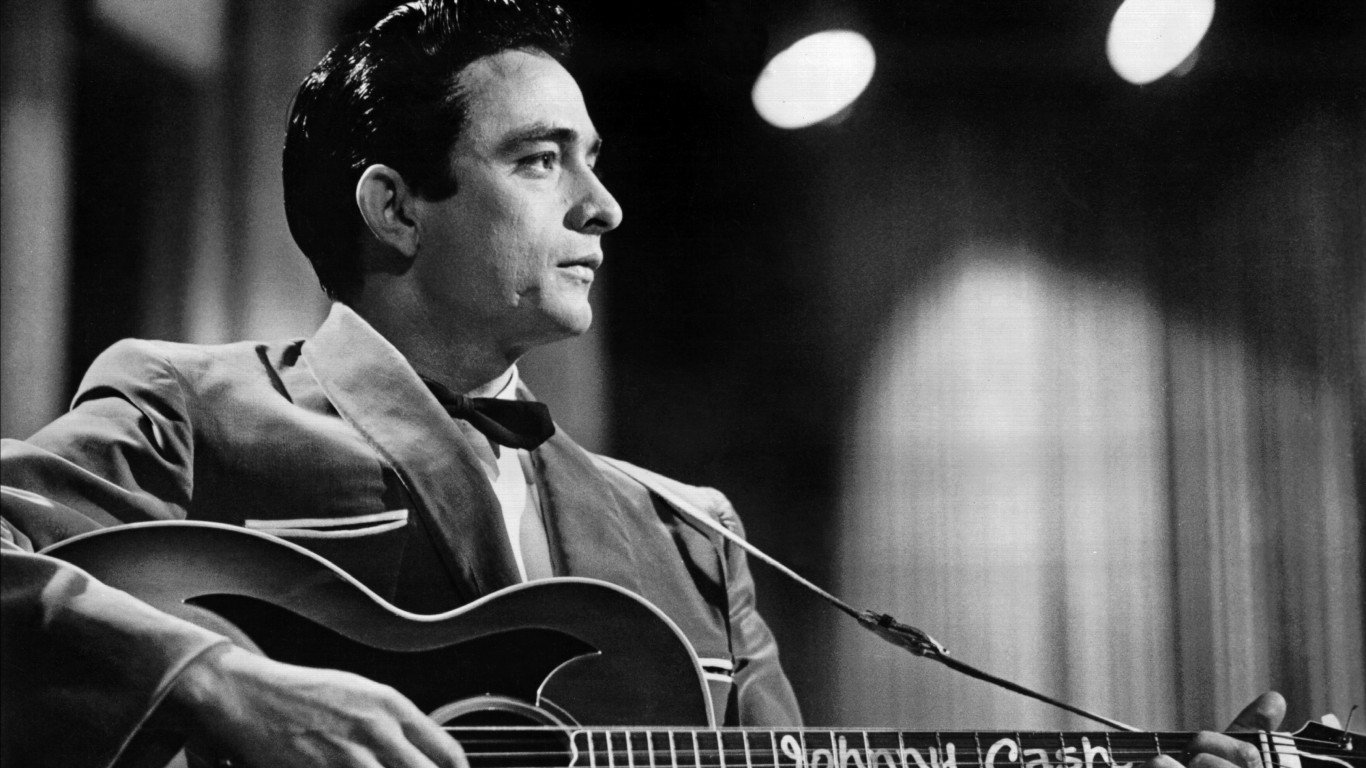 1957:  Country singer/songwriter Johnny Cash performs onstage with an acoustic guitar in Sun Records publicity shot in 1957. (Photo by Michael Ochs Archives/Getty Images)