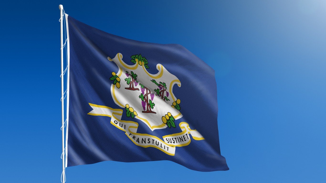 The flag of the state of Connecticut blowing in the wind in front of a clear blue sky