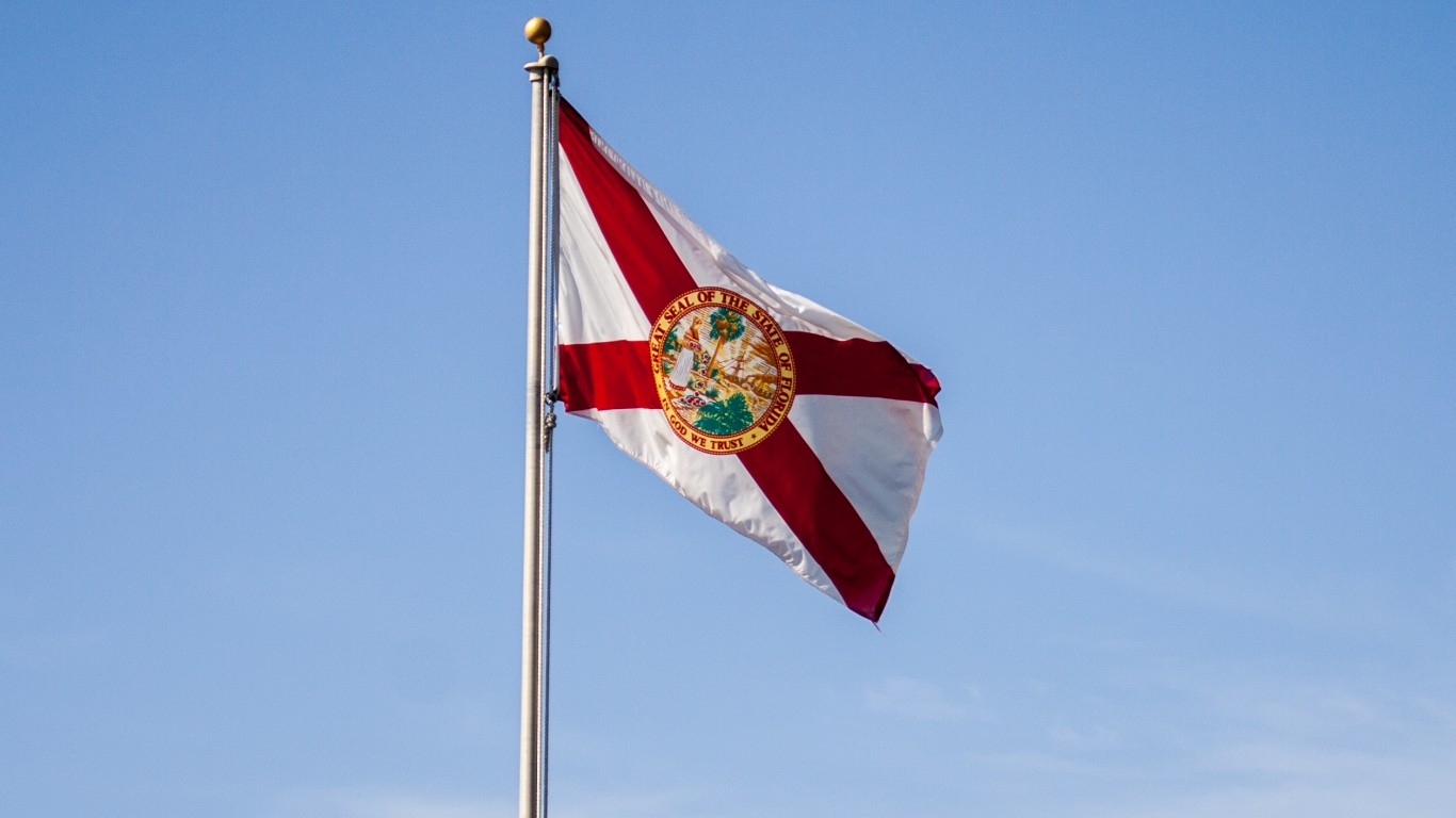 Florida state flag waving in the wind on a clear day.