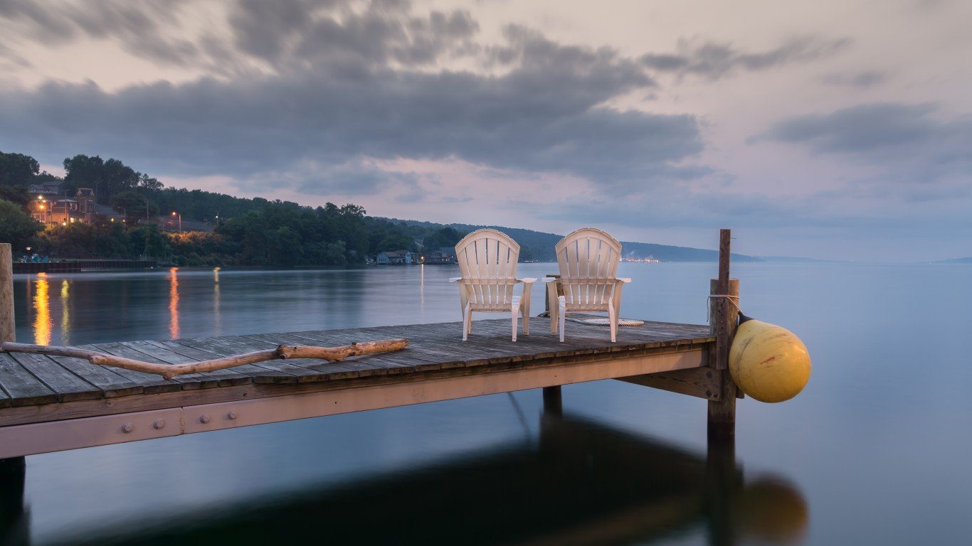 Two chairs sitting on a jetty at dusk, form a tranquil and idyllic scene at Lake Seneca, a popular vacation destination and located in the famous Finger Lakes region in New YorkState.