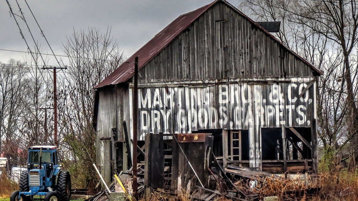 Sign on a Barn and Tractor by Don O'Brien