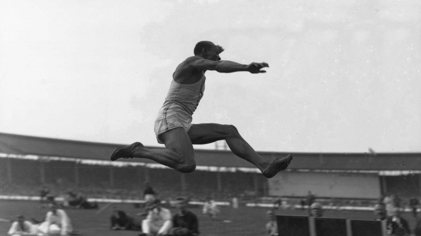 1936: JESSE OWENS COMPETES IN THE LONG JUMP DURING AN ATHLETICS MEET BETWEEN THE USA AND GREAT BRITAIN AT WHITE CITY. 
