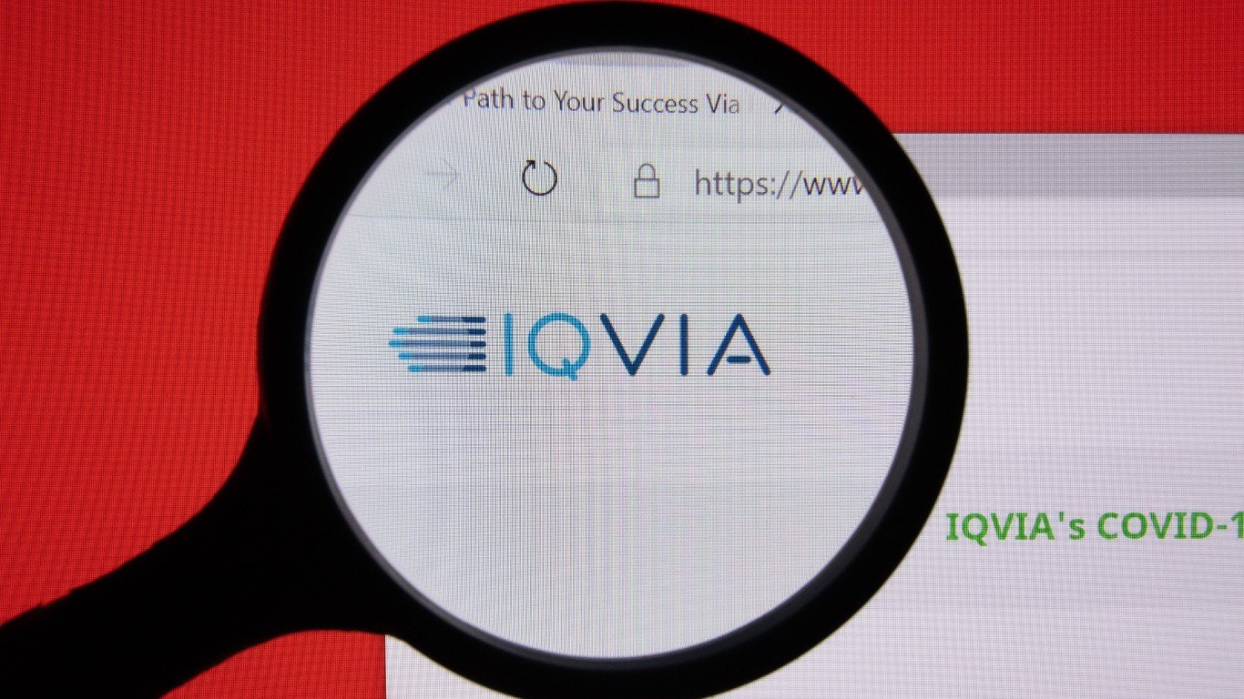 IQVIA company website page logo on laptop display with red background by Jernej Furman