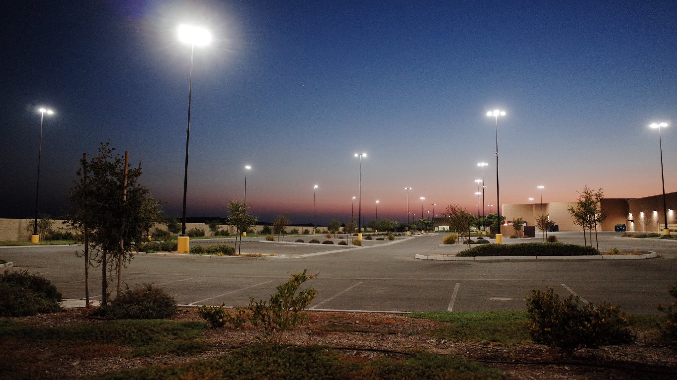 Strip mall parking lot after dark. Delano, CA. by Kathy Drasky