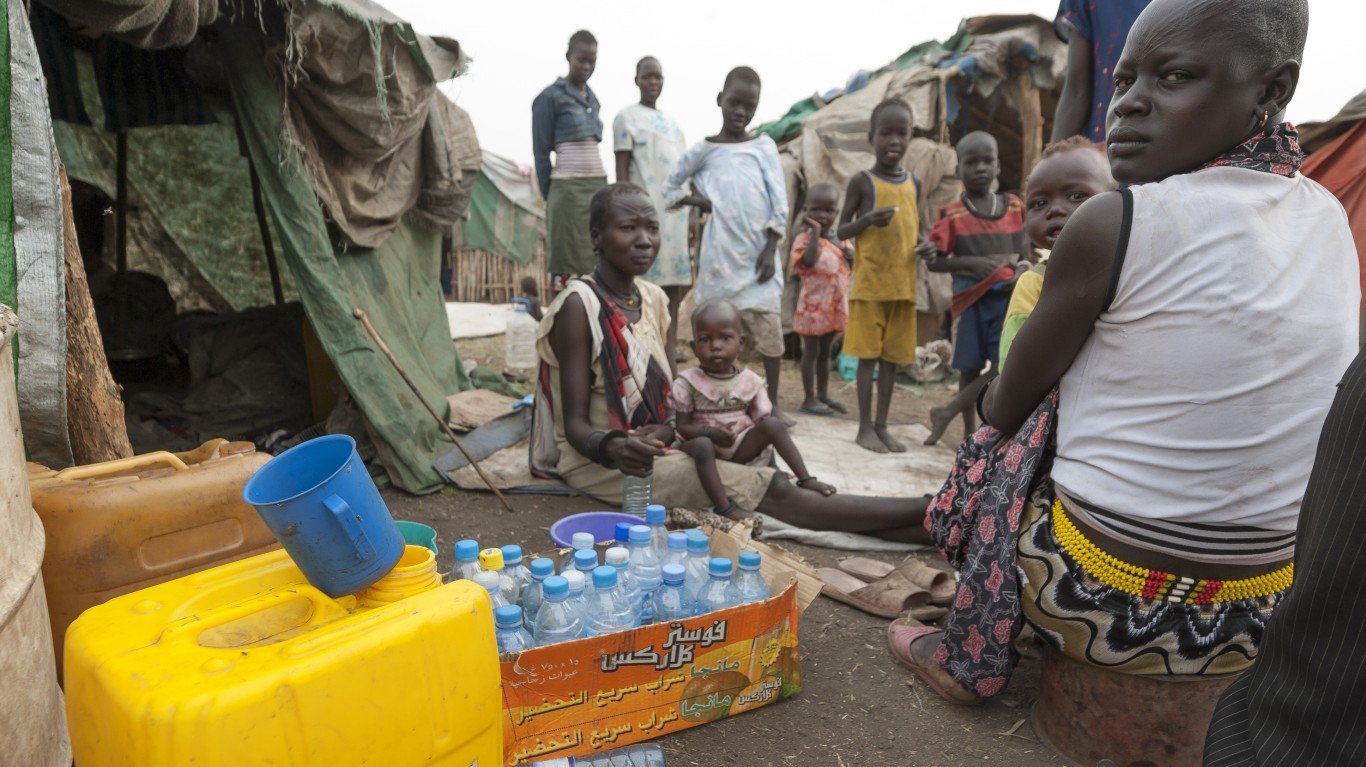 Juba, South Sudan - Unidentified people prepare plastic containers to collect water in refugee camp, Juba, South Sudan