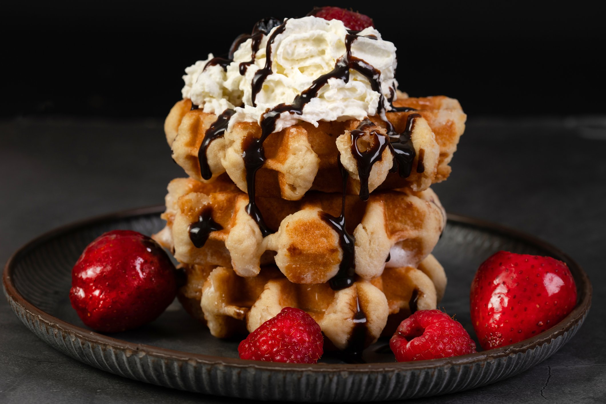Belgian waffles with whipped cream and berries