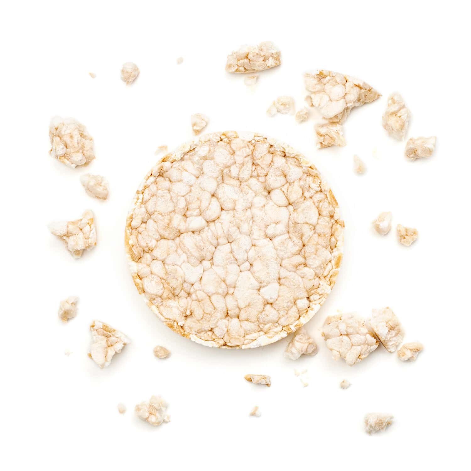 Puffed rice cake shaped in the form of a circle. Overhead close up view, isolated on white background
