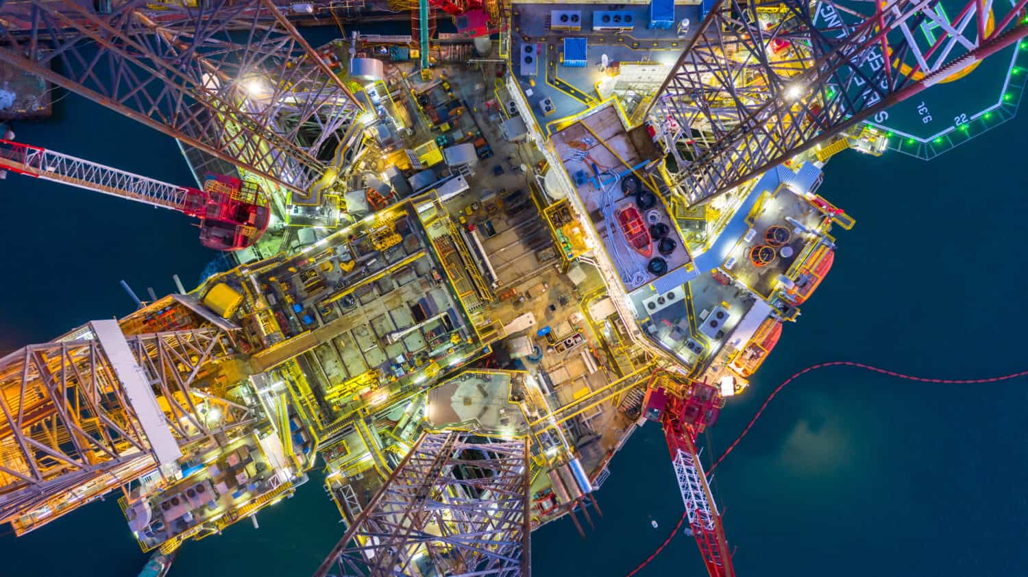 Aerial view offshore jack up rig at night, Offshore oil rig drilling platform, Maintenance.