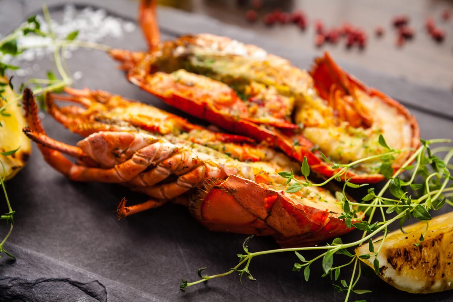 Lobster with flavored butter. Herb butter, lemon. Delicious healthy traditional food closeup served for lunch in modern gourmet cuisine restaurant