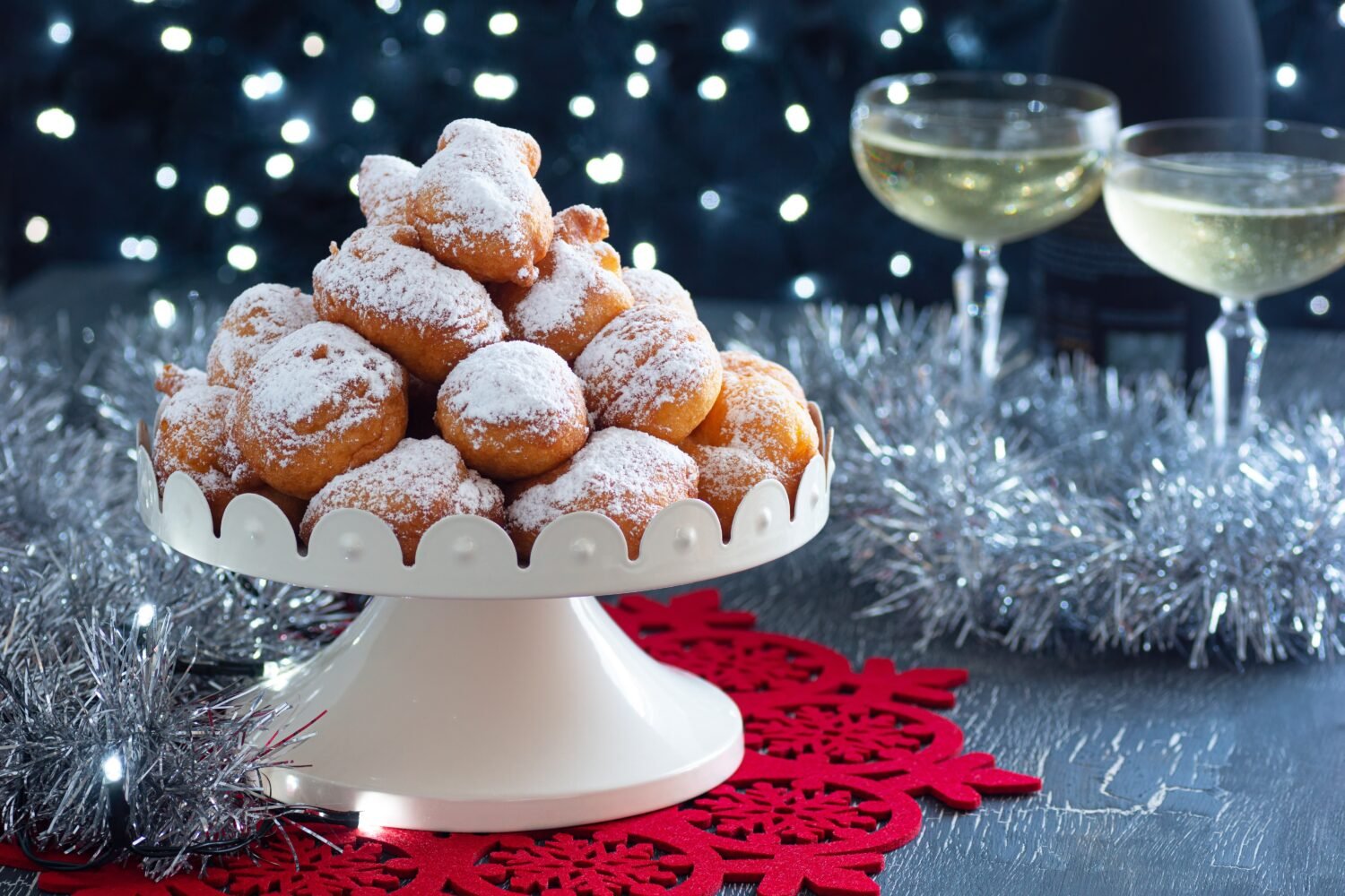 Oliebollen, Smoutballen, or Oil Balls, a Dutch Fried Dough Dumpling Pastry with Powdered Sugar from the Netherlands Served for New Year's Eve