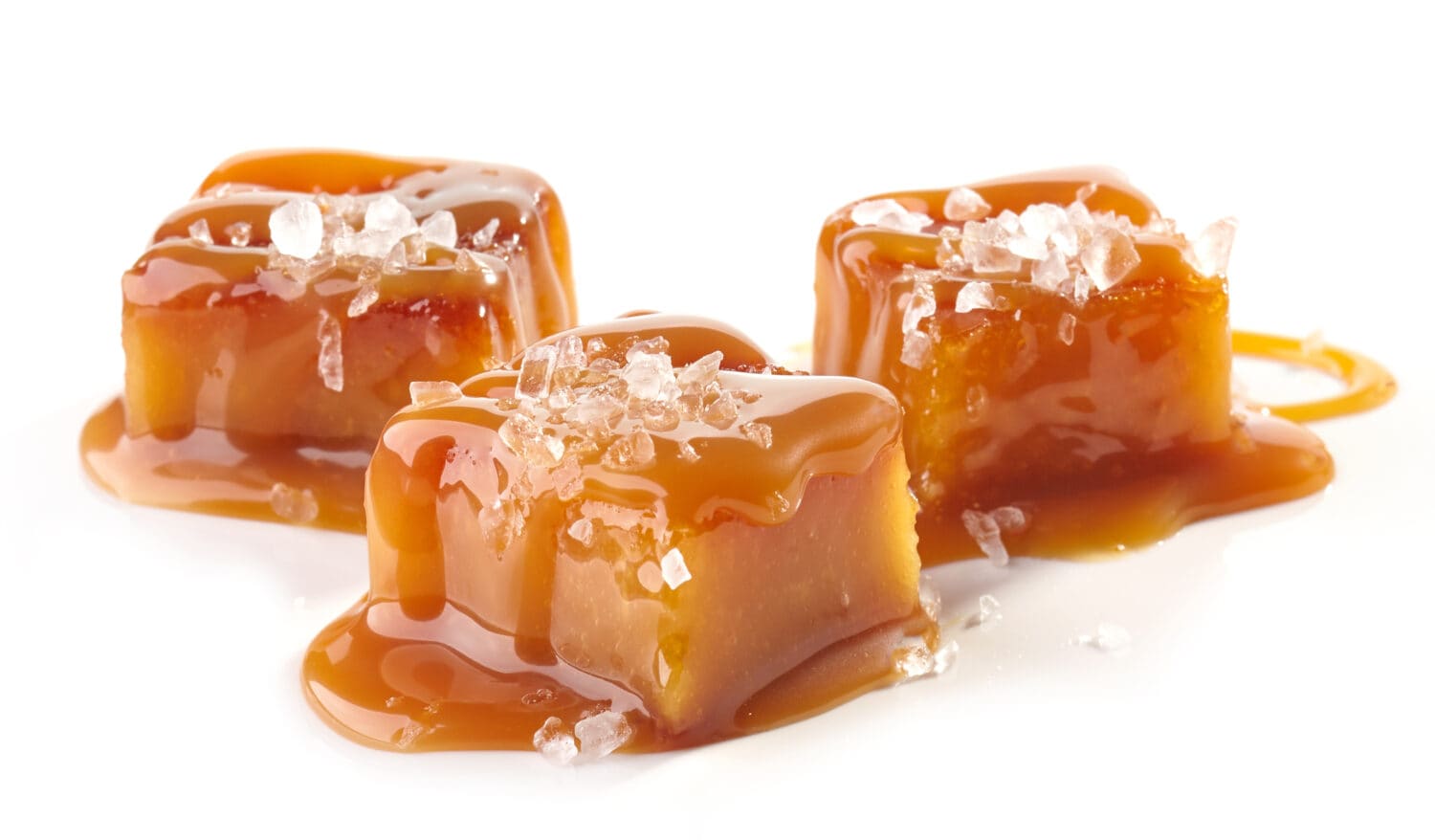 homemade salted caramel pieces isolated on white background
