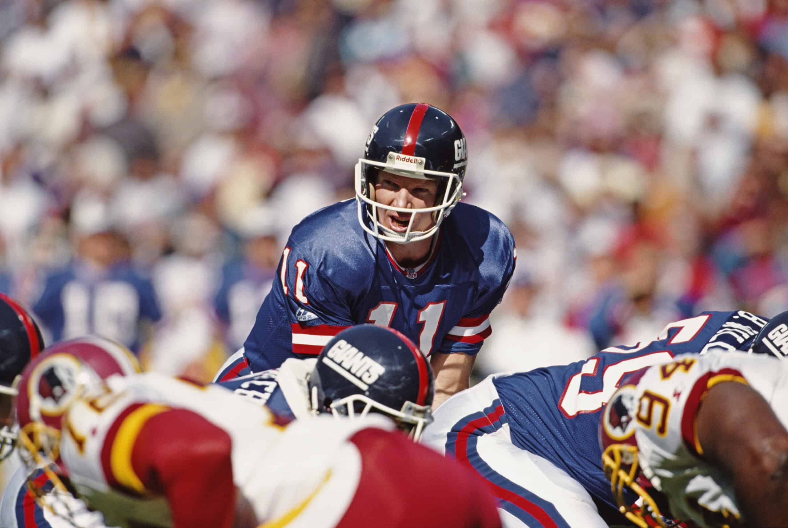 Phil Simms #11, Quarterback for the New York Giants calls the play during the National Football Conference East game against the Washington Redskins on 10th October 1993 at the Giants Stadium, East Rutherford, New Jersey, United States. The Giants won the game 41 - 7.  (Photo by Rick Stewart/Allsport/Getty Images)