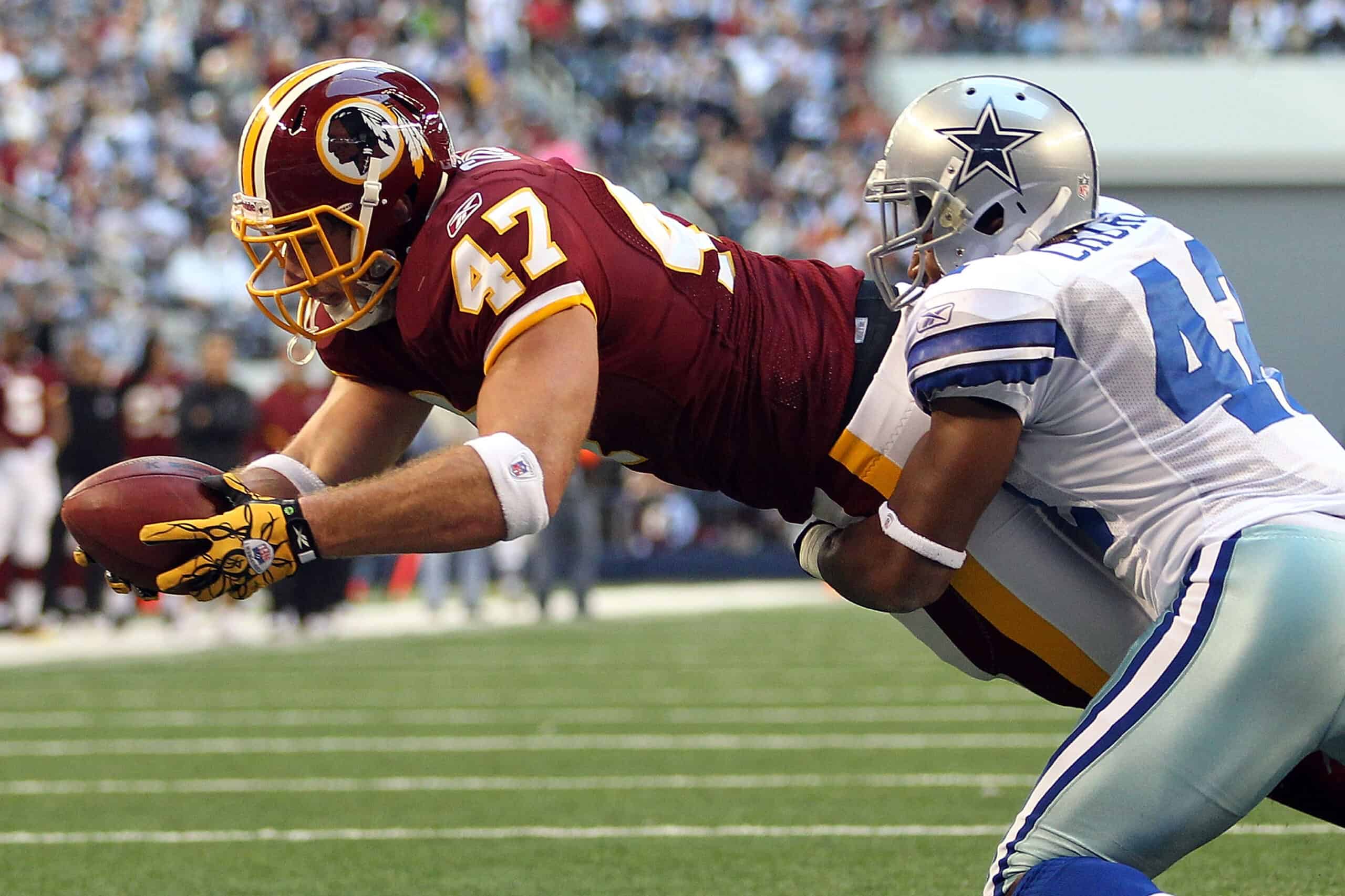 ARLINGTON, TX - DECEMBER 19: Tight end Chris Cooley #47 of the Washington Redskins dives on a two point conversion against Barry Church #42 of the Dallas Cowboys at Cowboys Stadium on December 19, 2010 in Arlington, Texas. (Photo by Ronald Martinez/Getty Images)