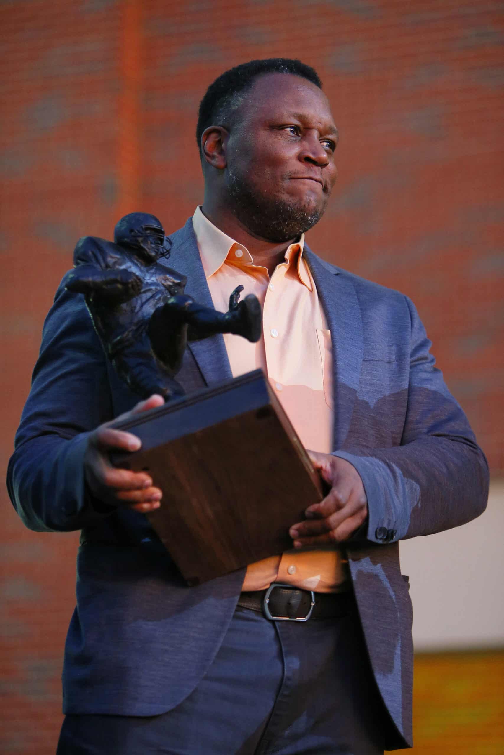 STILLWATER, OK - NOVEMBER 13: Barry Sanders acknowledges fans after a statue was unveiled in his honor by the Oklahoma State Cowboys at Boone Pickens Stadium on November 13, 2021 in Stillwater, Oklahoma. Sanders is holding a miniature version of the statue. (Photo by Brian Bahr/Getty Images)