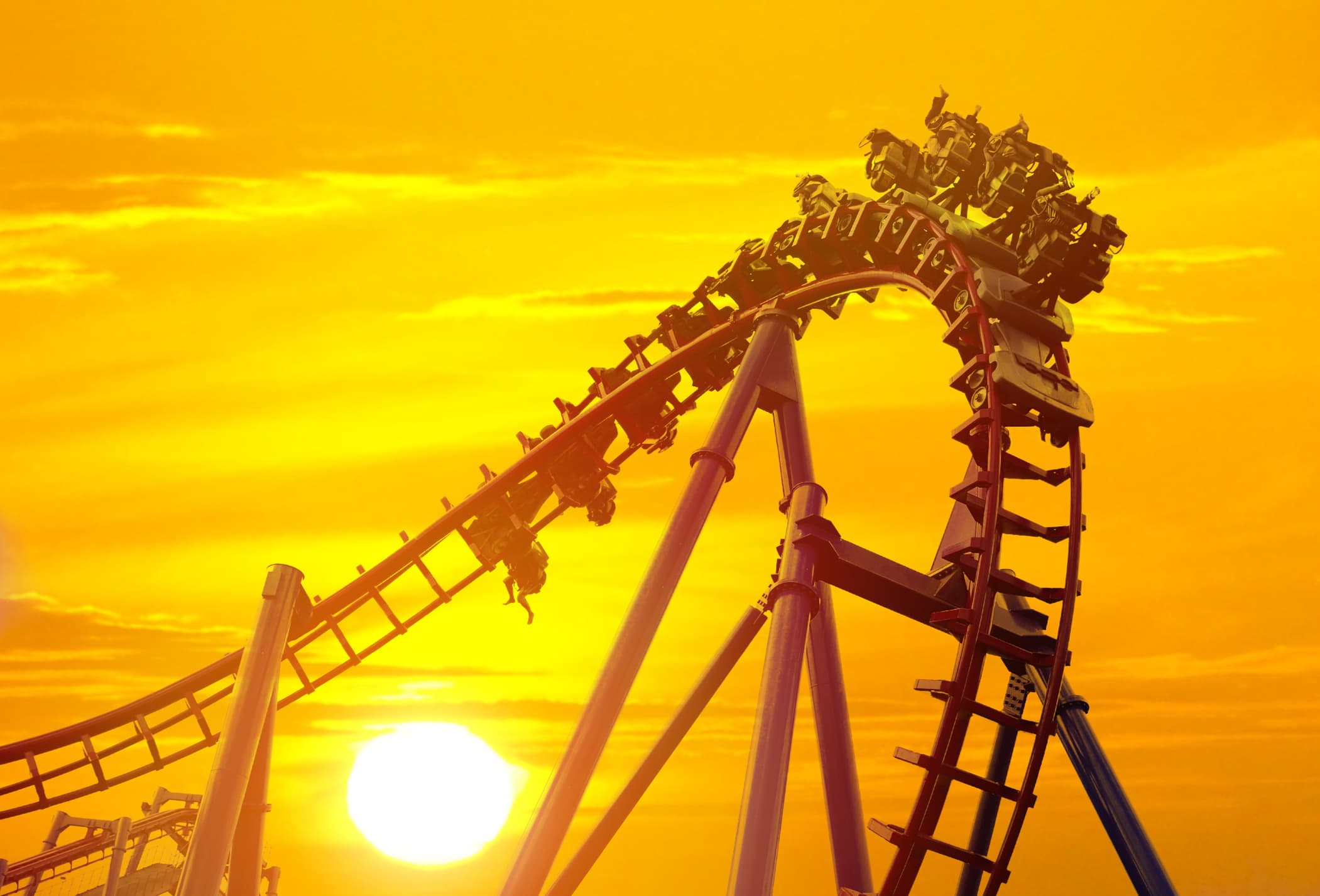 Roller coaster in the amusement park with the sunset background.