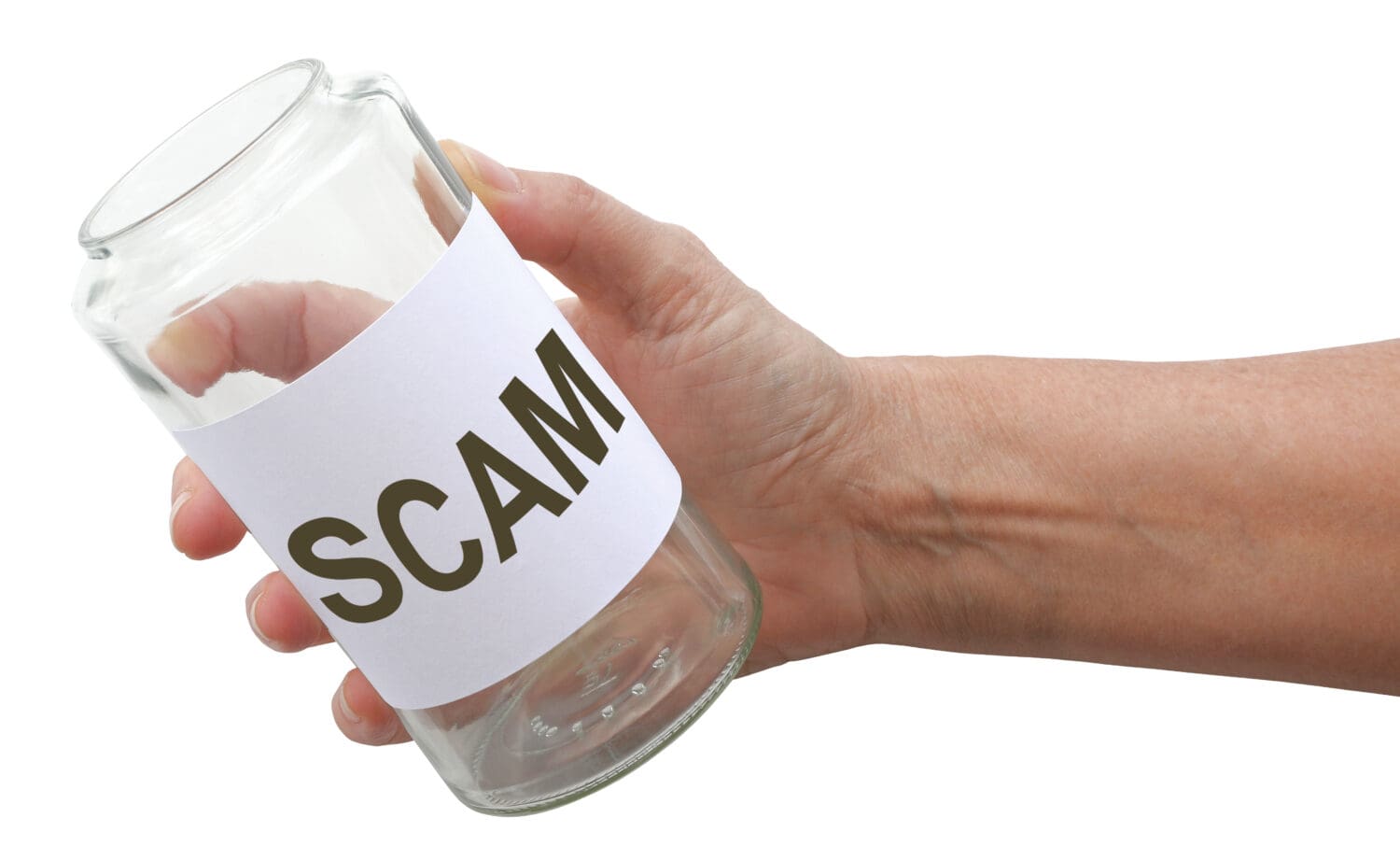 Beware of scammers asking for Money - hand holding a glass jar with a label saying SCAM isolated on a white background