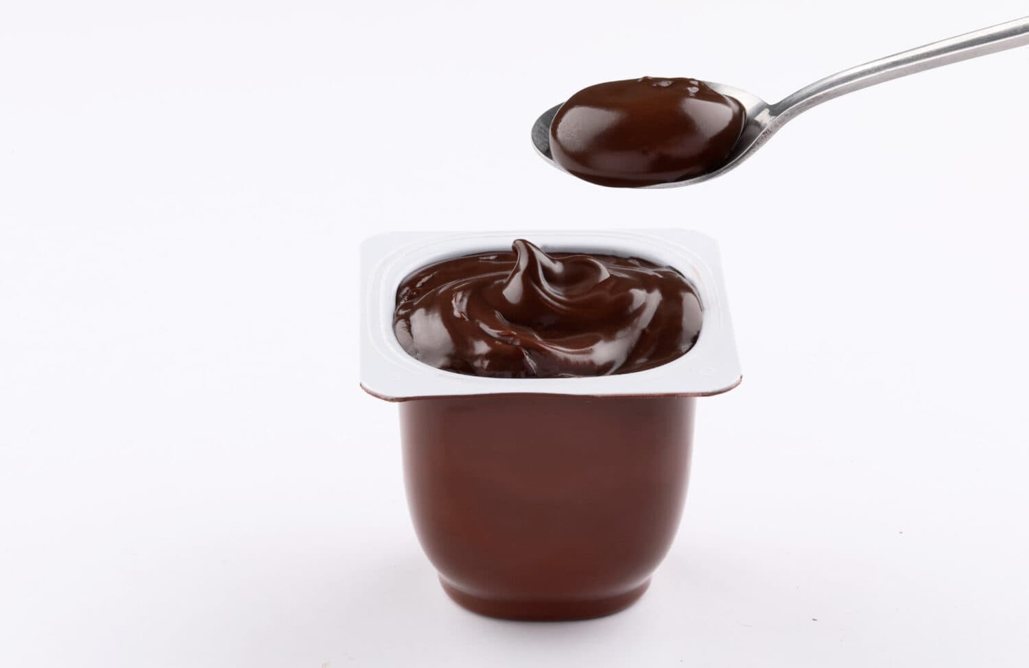 chocolate pudding brown cup plastic with spoon isolated on white background