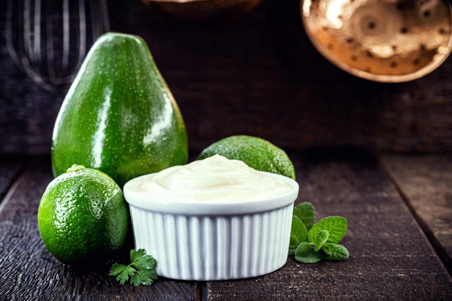 vegan mayonnaise made from avocado cream with lemon, called green mayonnaise. Vegetarian food.