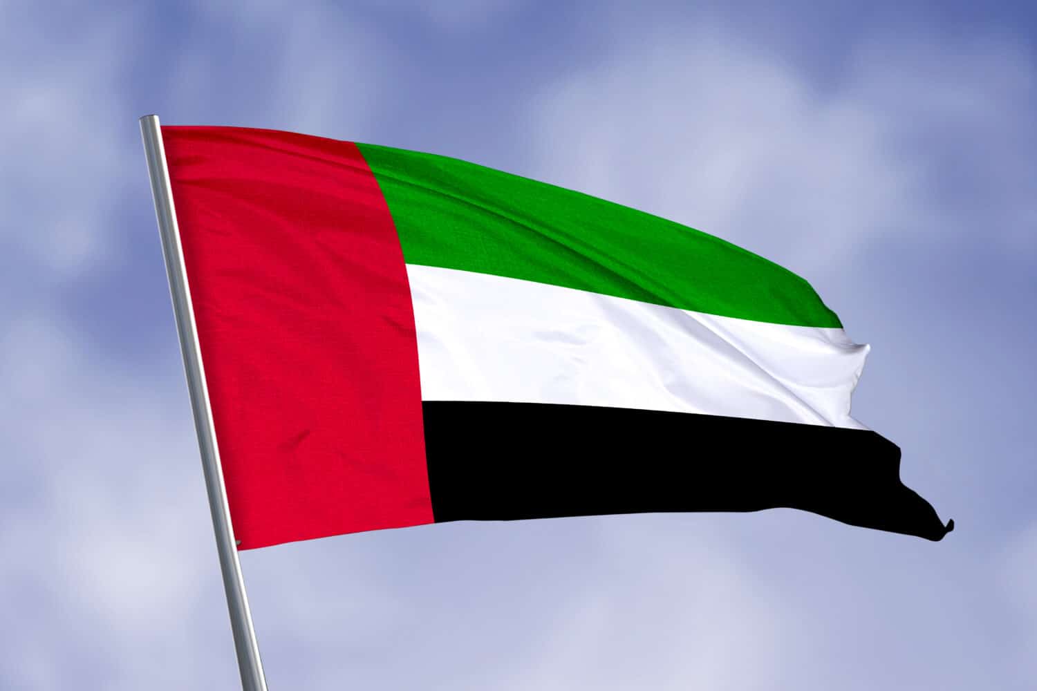 United Arab Emirates flag isolated on sky background. close up waving flag of United Arab Emirates. flag symbols of United Arab Emirates.