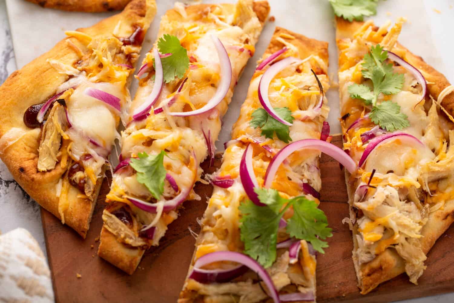 Barbeque chicken flatbread with BBQ sauce, cheese and red onion