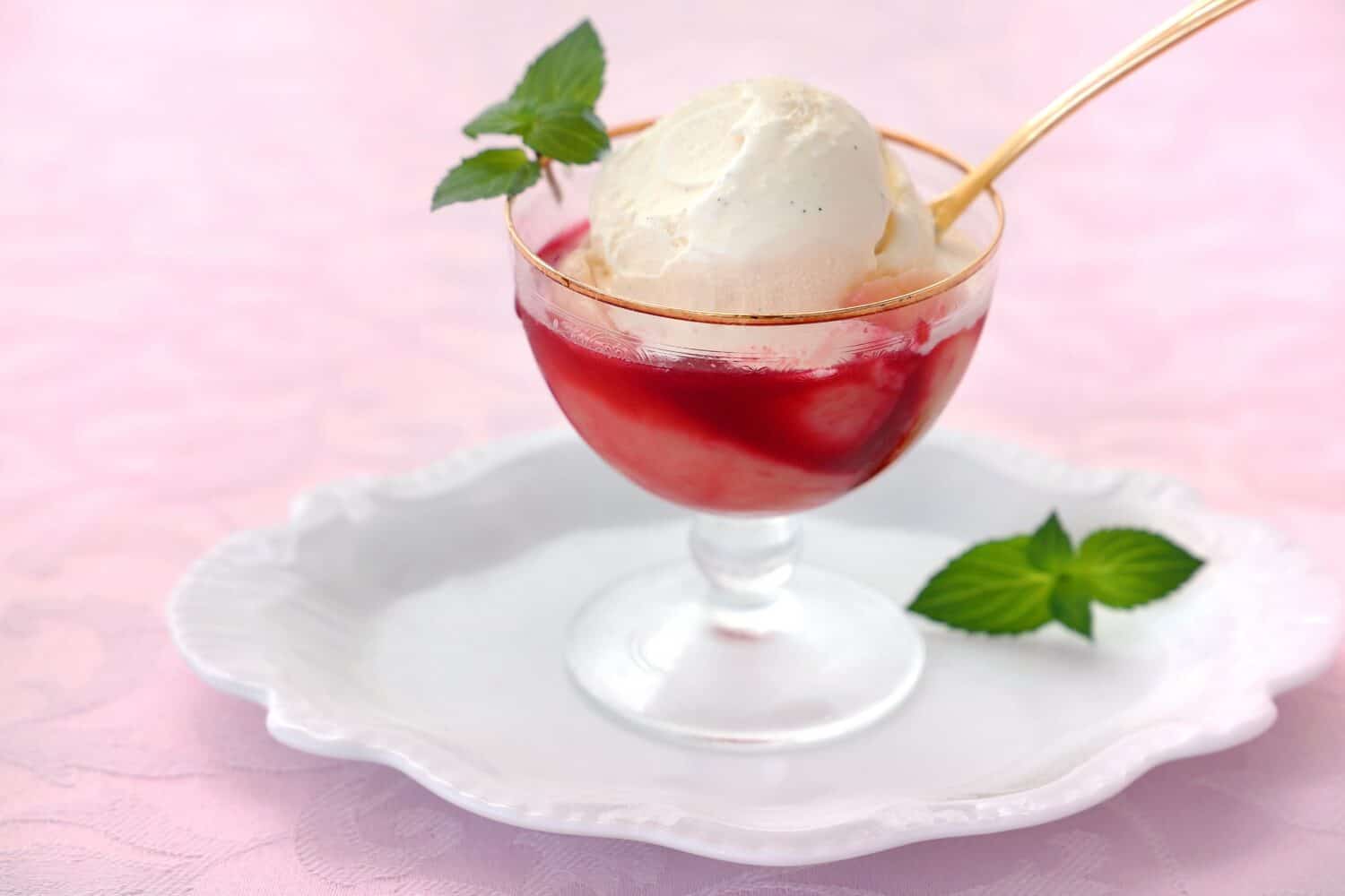 Summer dessert peach melba made with homemade peach compote and raspberry sauce