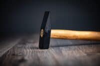 hammer handle carpenter tool on the wood background,