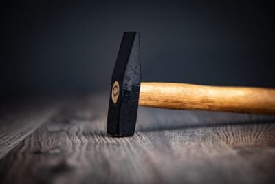 hammer handle carpenter tool on the wood background,