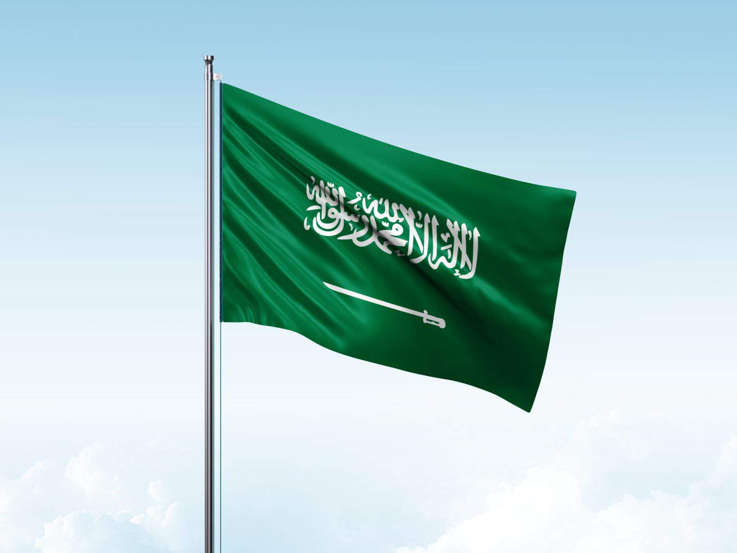 Saudi Arabia flag in the blue sky.