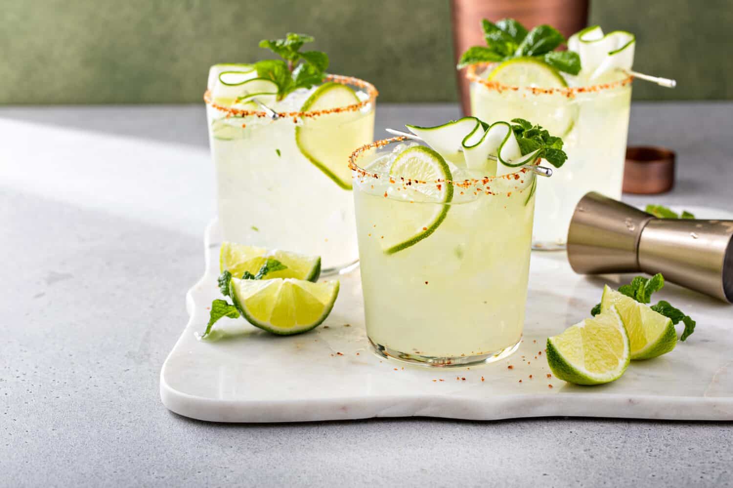 Cucumber margarita with lime and spicy rim, refreshing spring cocktail with copy space