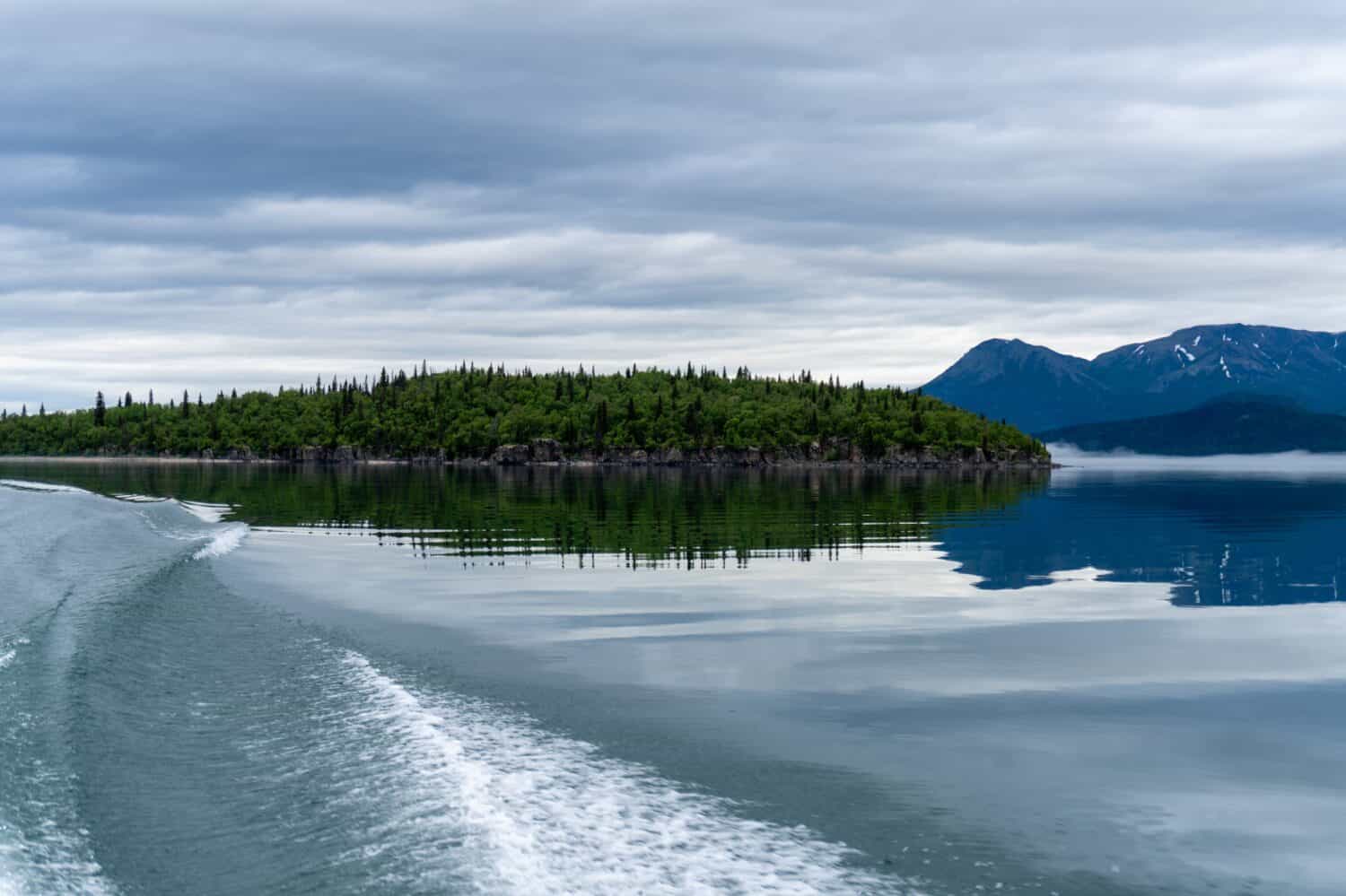 Lake Clark National Park, Alaska. Lake Clark in Lake Clark National Park and Preserve in Alaska. Turquoise lake with rugged mountains, islands and shore. Denaʼina: Qizhjeh Vena. Tommy Island, wake.