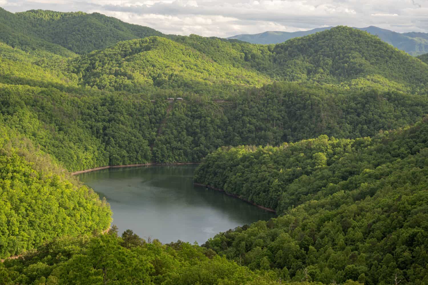 Fontana Lake in the Smoky Mountains - A serene landscape featuring Fontana Lake surrounded by majestic mountains, showcasing the harmonious beauty of nature's reflection and the peaceful serenity.