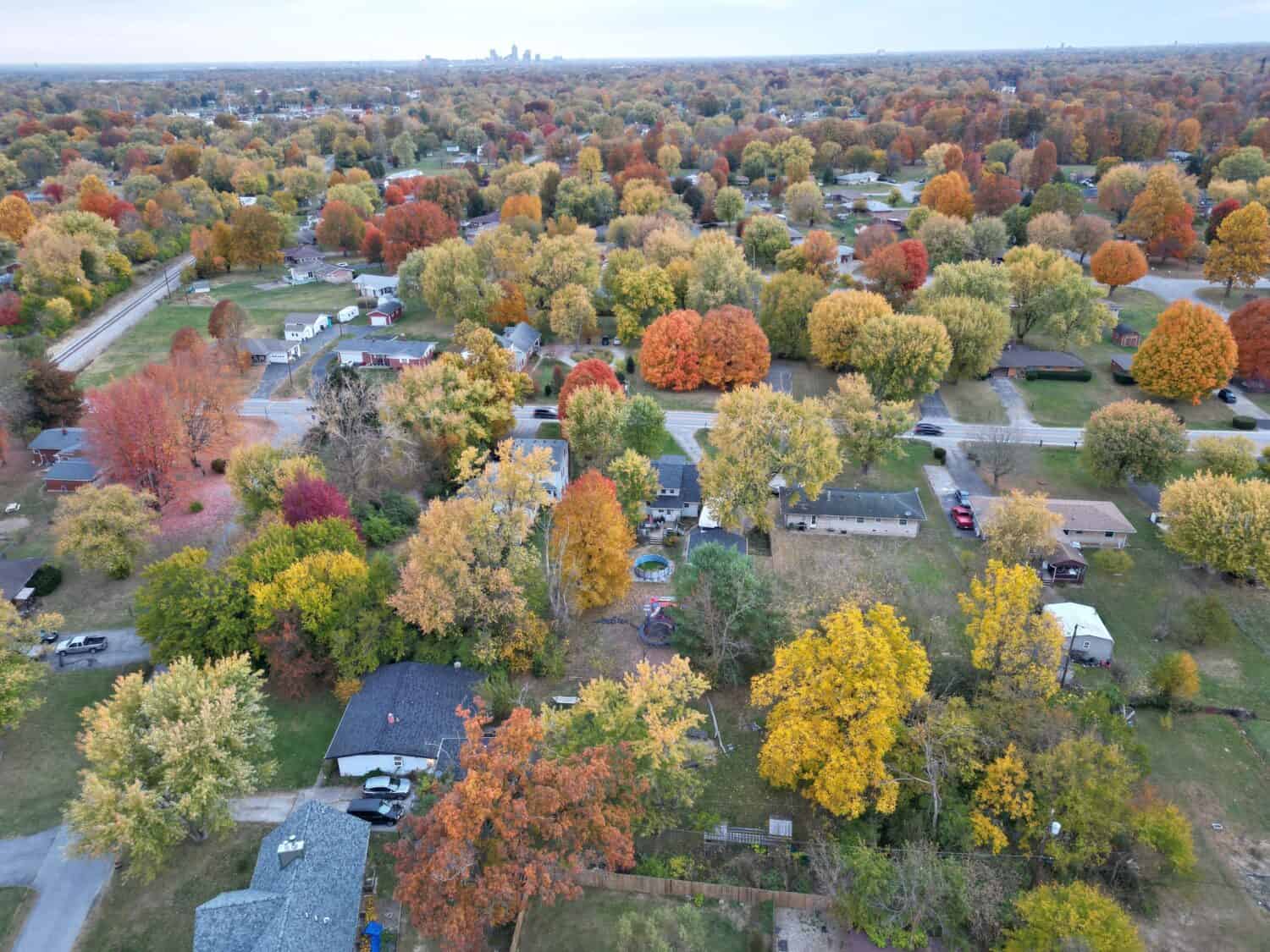 An aerial view of a calm neighborhood in Indianapolis surrounded by colorful autumn trees. The USA.