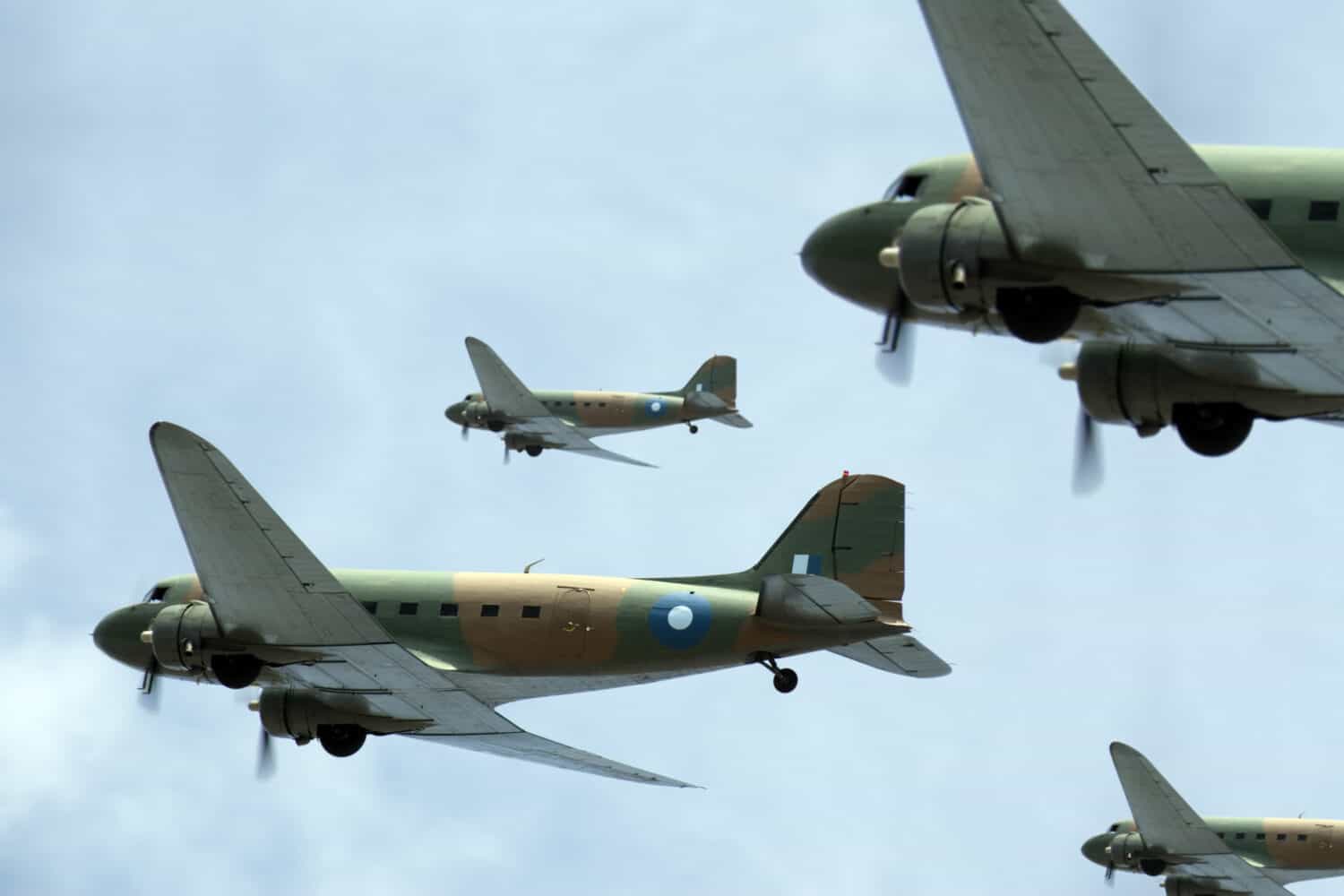 A flight of Dakota (Douglas C-47) transport planes banking to starboard. (Created with minimum depth of field. Focus is on the second aircraft from the front.)