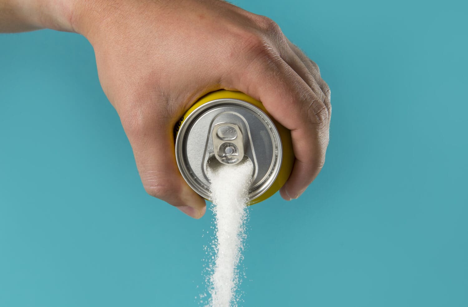 man pouring sugar from a can