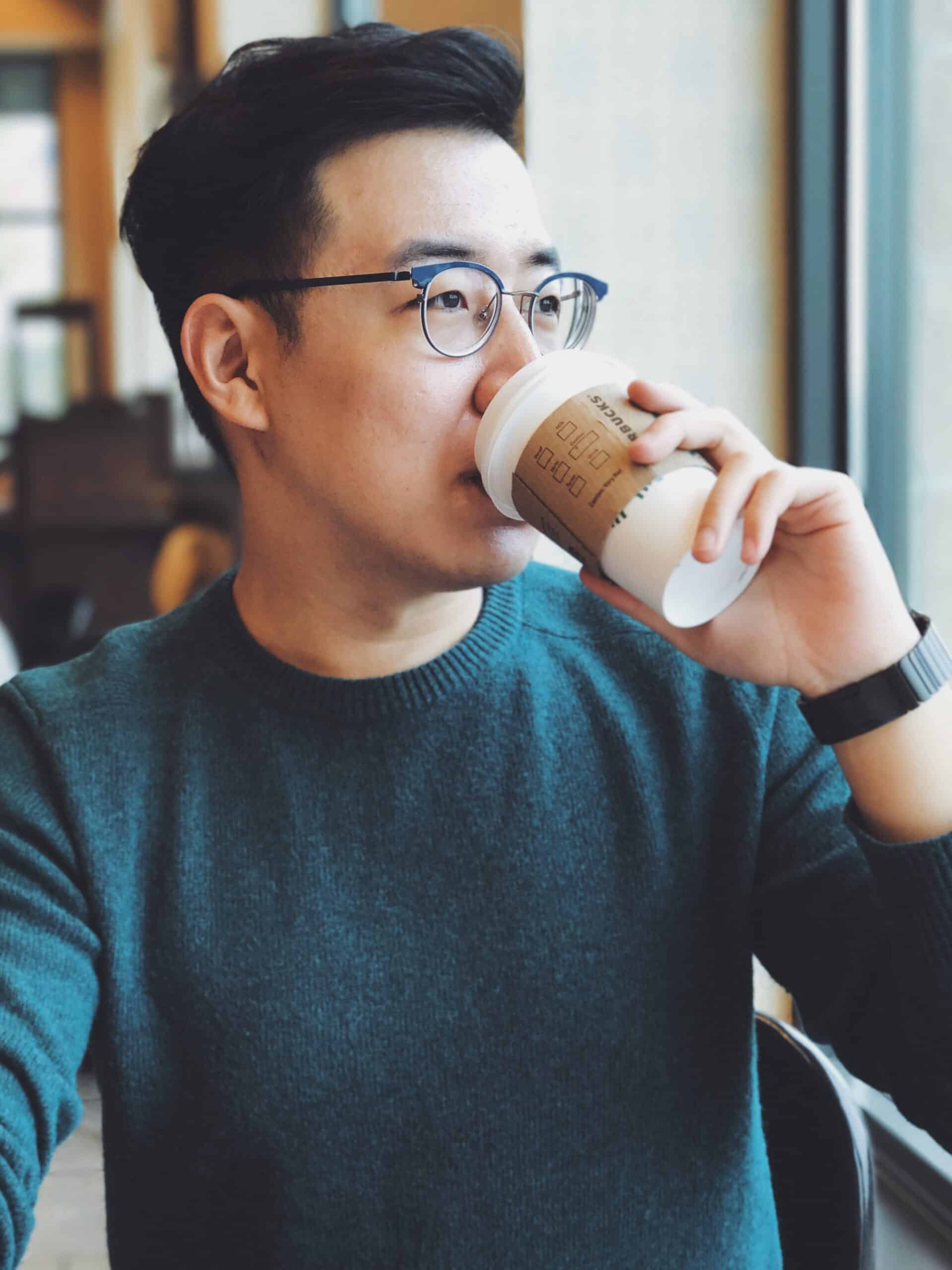 Man drinking from a Starbucks cup
