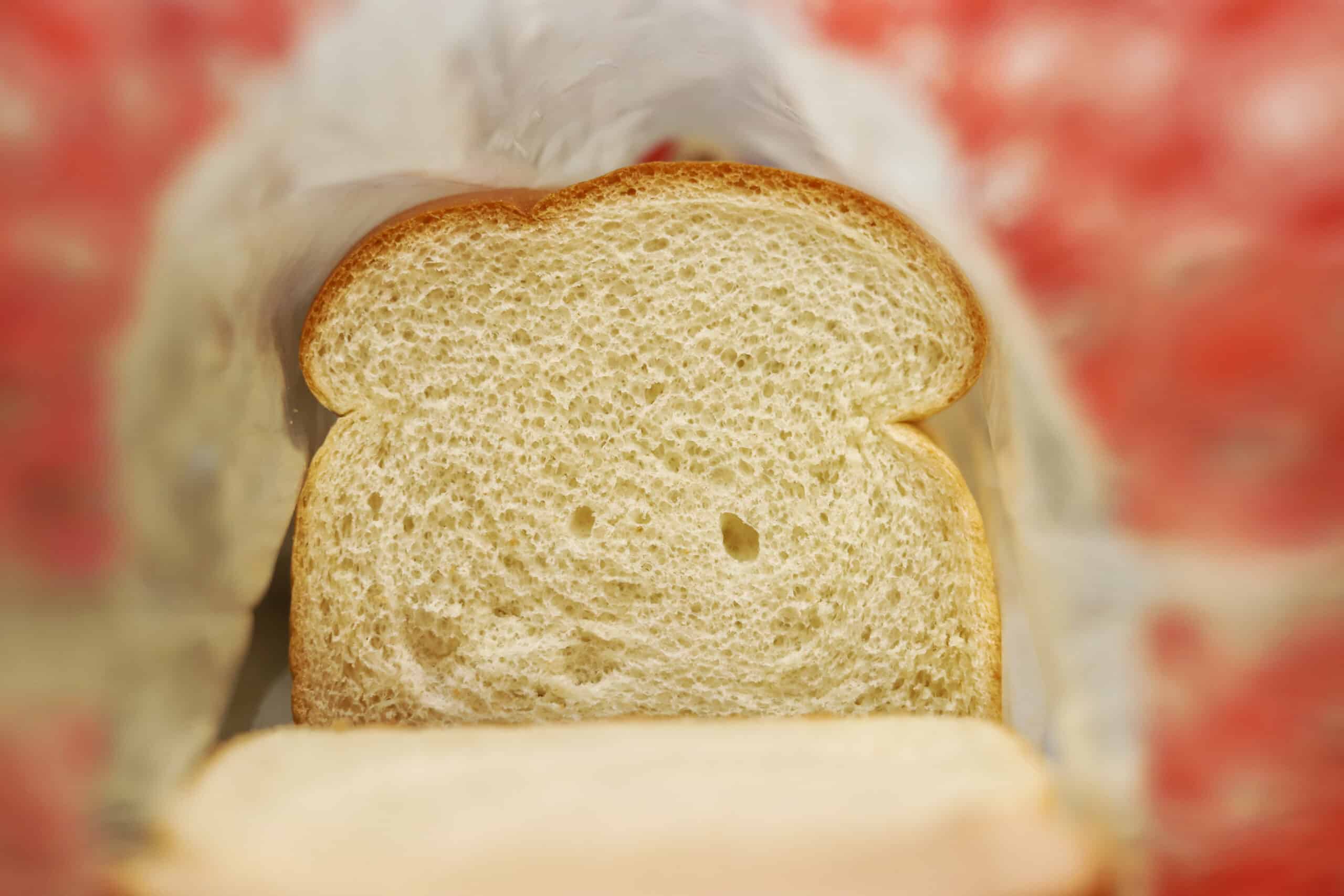 A close up image of a slice of white bread in a bag