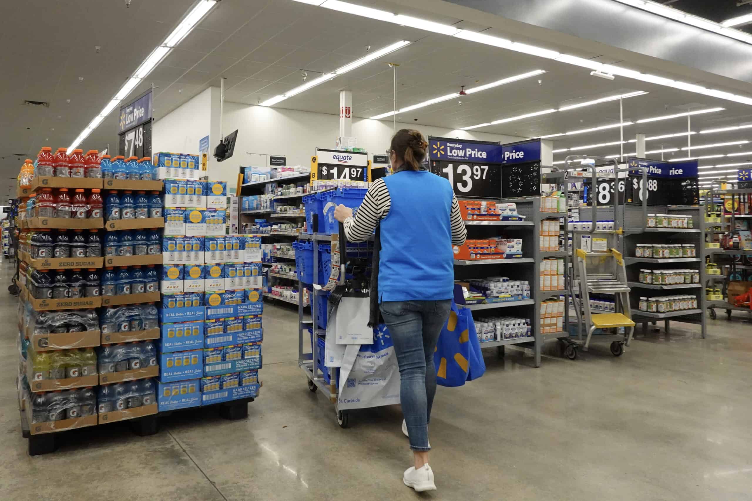 A worker walks through the aisles in a Walmart Supercenter on February 20, 2024, in Hallandale Beach, Florida. 