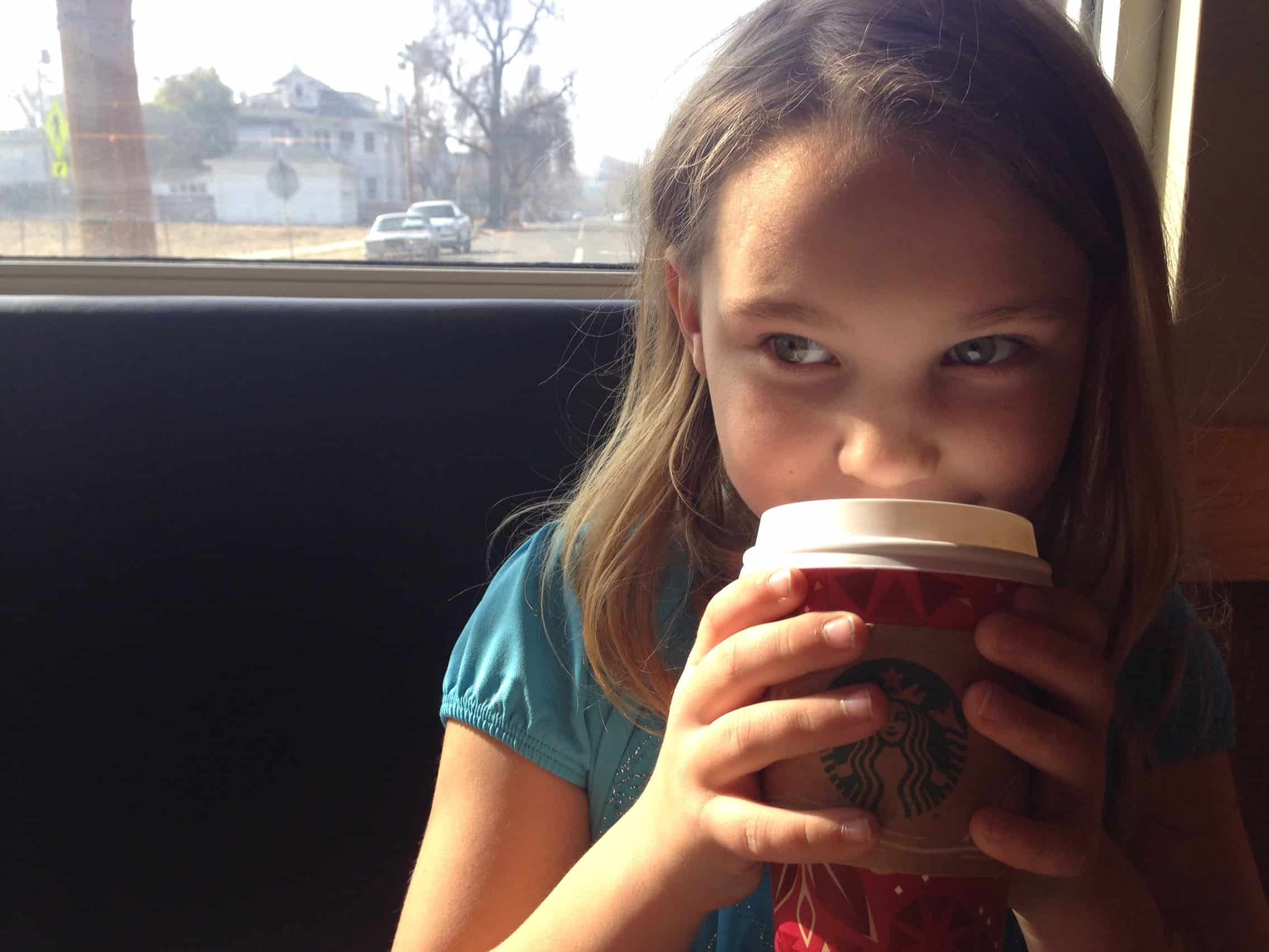 Young girl at Starbucks drinking hot chocolate