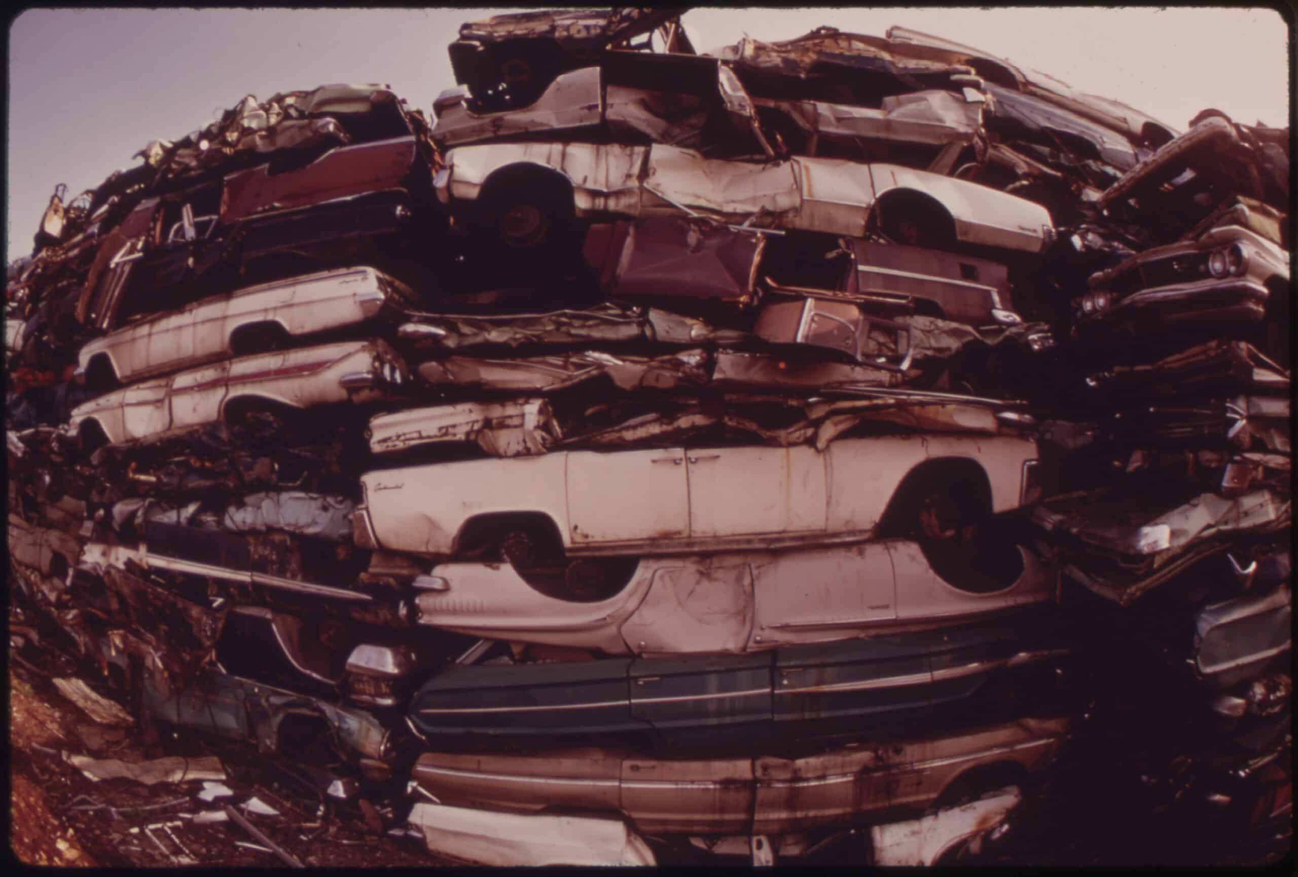 Stacked cars in city junkyard