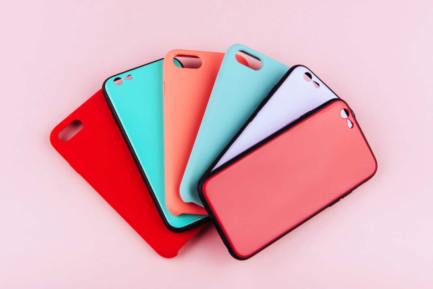 Set of colored silicone covers for smart phone on a colorful background