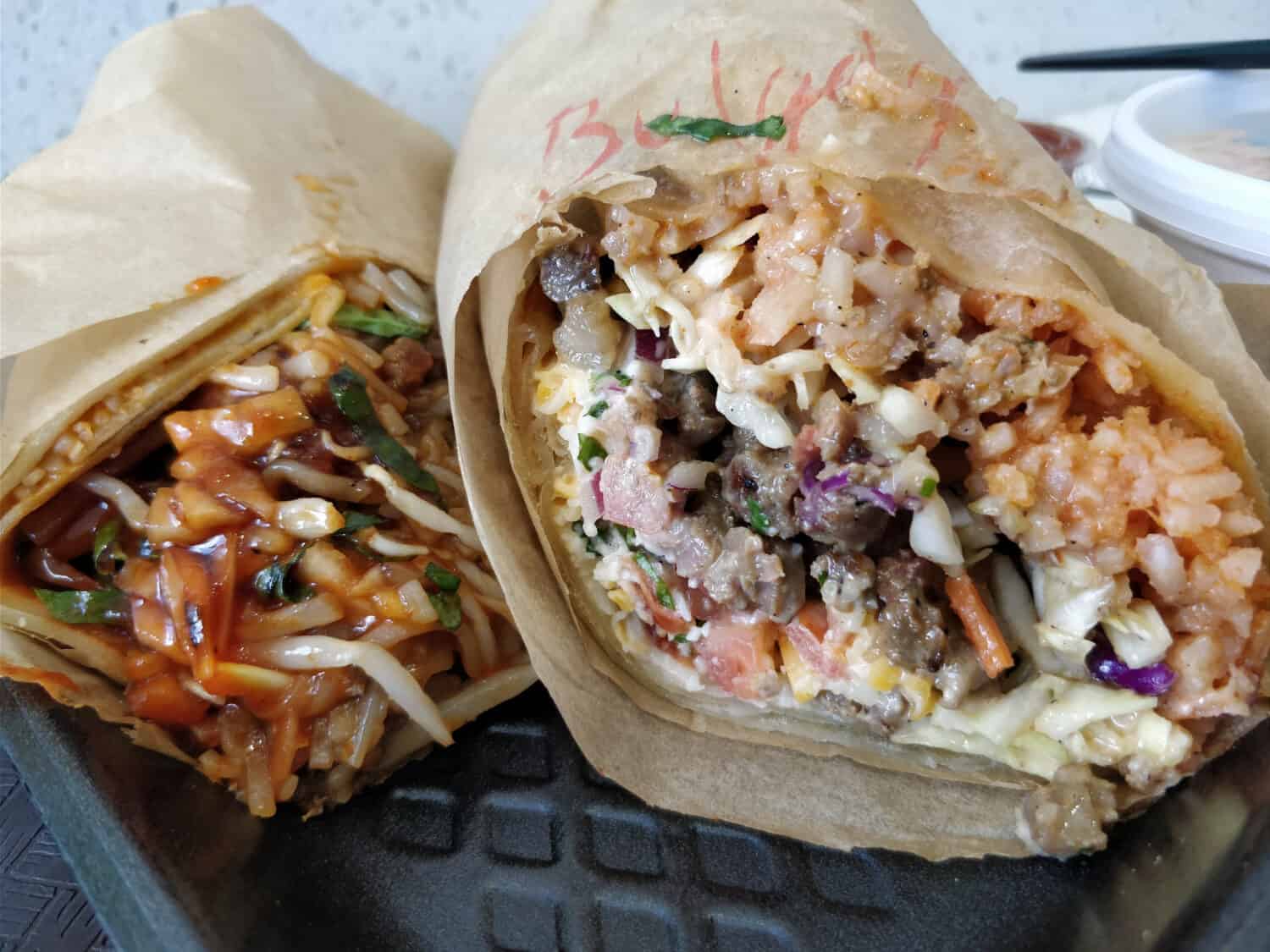 Asian fusion food, a Korean bulgolgi beef burrito and a Vietnamese pho burrito.